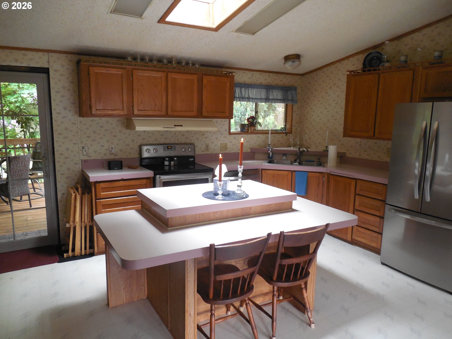 41180 Southeast Kubitz Road Sandy, OR 97055 - Photo 11 of 35 a kitchen with stainless steel appliances granite countertop a sink a stove a dining table and chairs