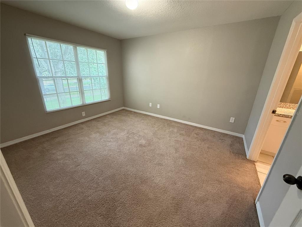 6312 Raleigh Street, Unit 512 Orlando, FL 32835 - Photo 4 of 17 an empty room with windows