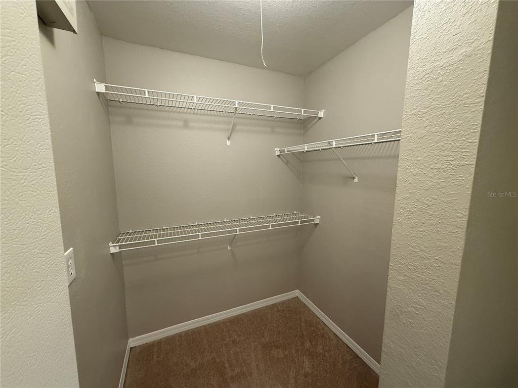 6312 Raleigh Street, Unit 512 Orlando, FL 32835 - Photo 9 of 17 a view of a room with racks on the wall