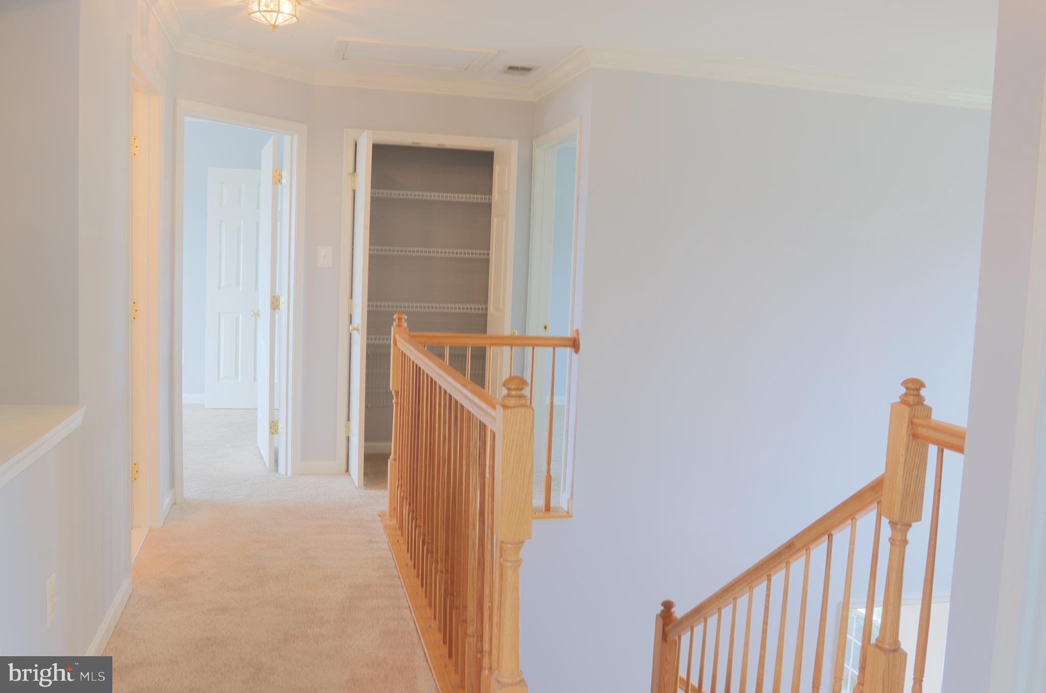14404 Autumn Crest Road Boyds, MD 20841 - Photo 56 of 103 a view of a hallway with wooden floor and staircase
