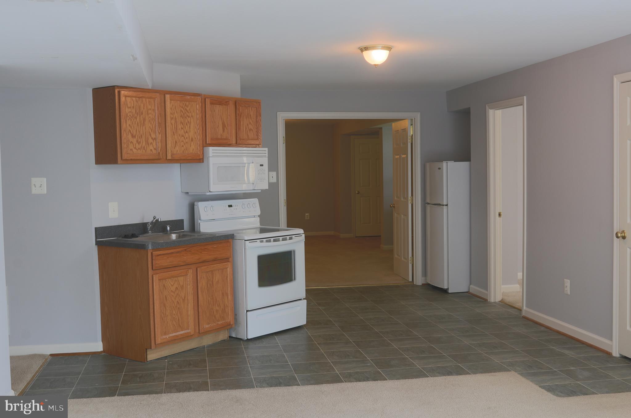 14404 Autumn Crest Road Boyds, MD 20841 - Photo 69 of 103 a kitchen with stainless steel appliances granite countertop a stove a sink and a refrigerator