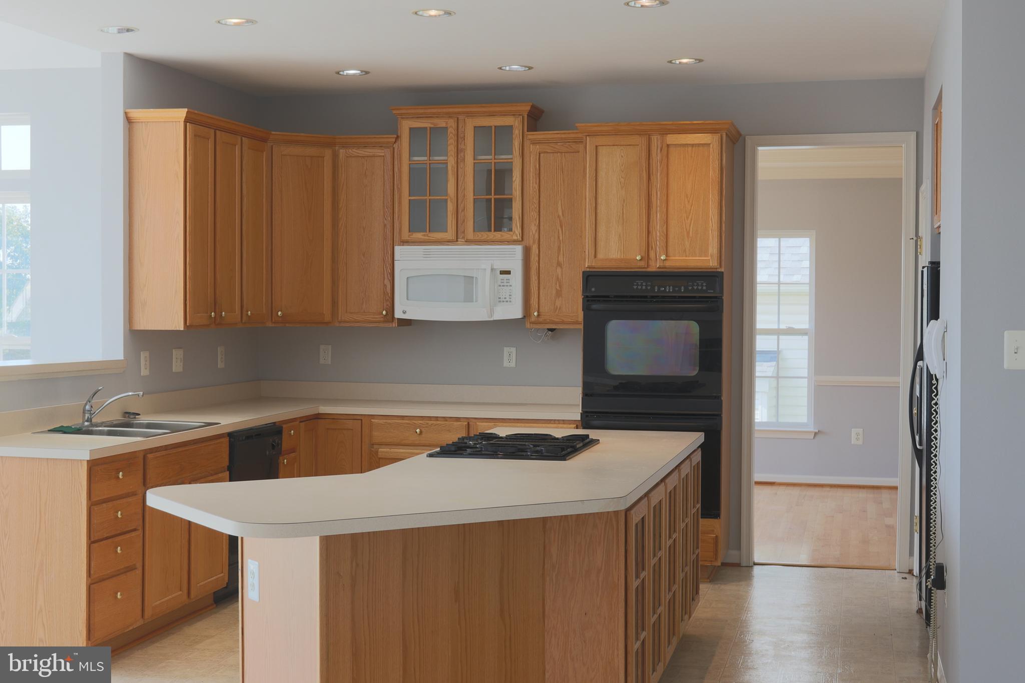 14404 Autumn Crest Road Boyds, MD 20841 - Photo 90 of 103 a kitchen with a stove a sink and a microwave