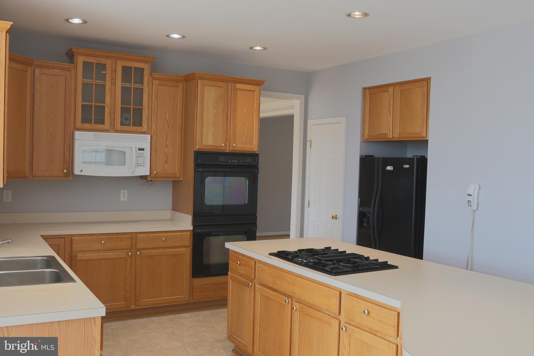 14404 Autumn Crest Road Boyds, MD 20841 - Photo 92 of 103 a kitchen with a stove and a refrigerator