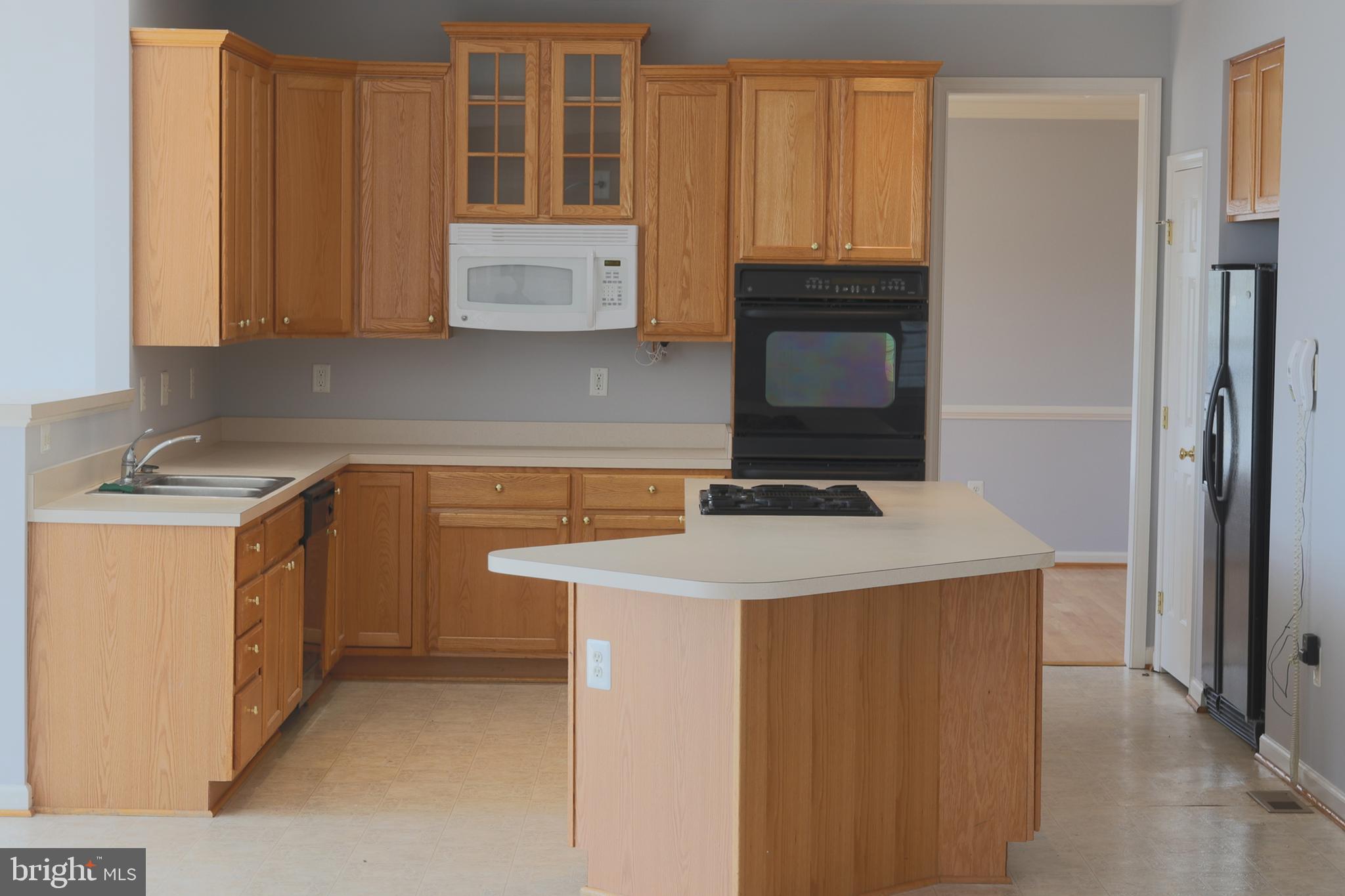 14404 Autumn Crest Road Boyds, MD 20841 - Photo 95 of 103 a kitchen with stainless steel appliances a stove a microwave a sink and cabinets