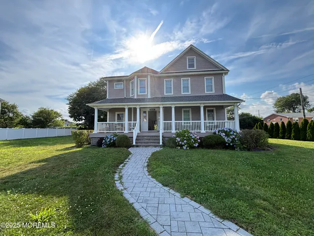 a front view of a house with garden and porch