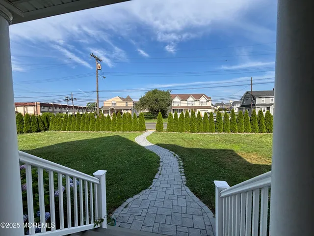 a view of a porch with furniture and garden