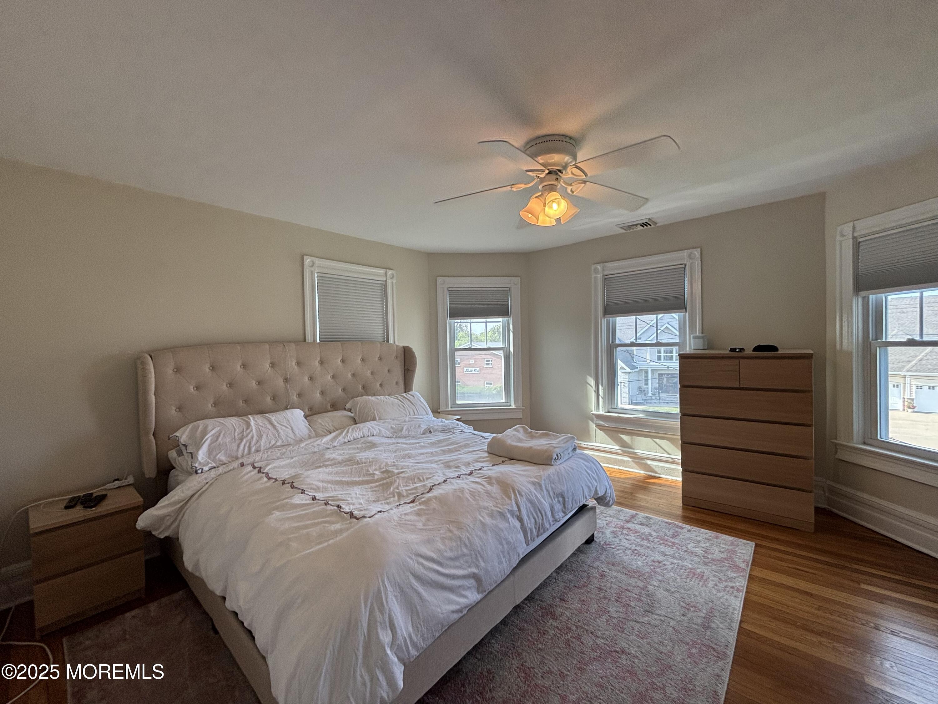 516 2nd Avenue Long Branch, NJ 07740 - Photo 20 of 52 a bedroom with a bed and a chandelier