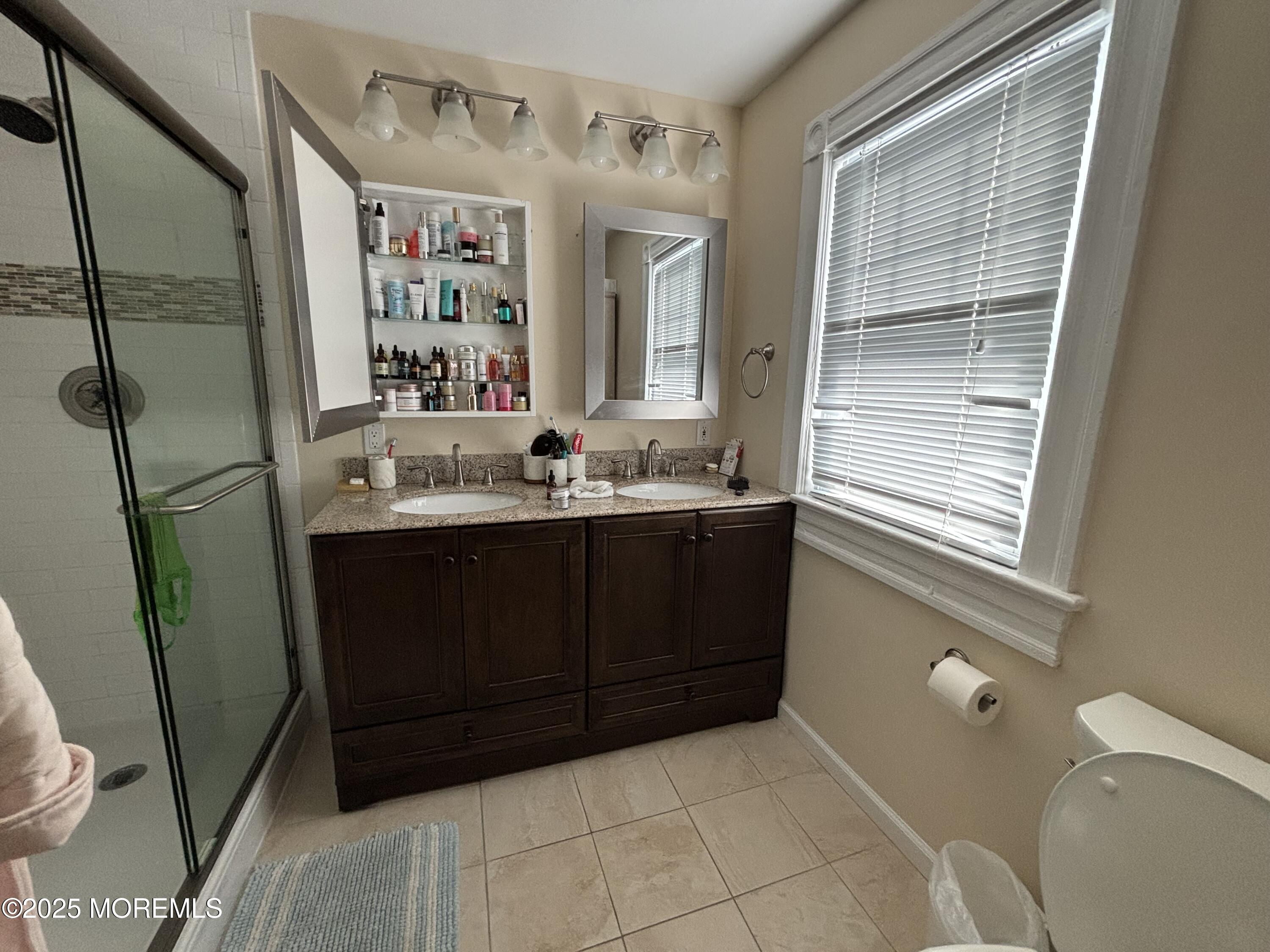 516 2nd Avenue Long Branch, NJ 07740 - Photo 21 of 52 a bathroom with a sink a vanity and a mirror