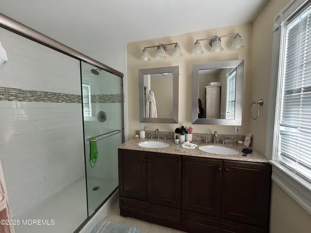 a bathroom with a double vanity sink and mirror
