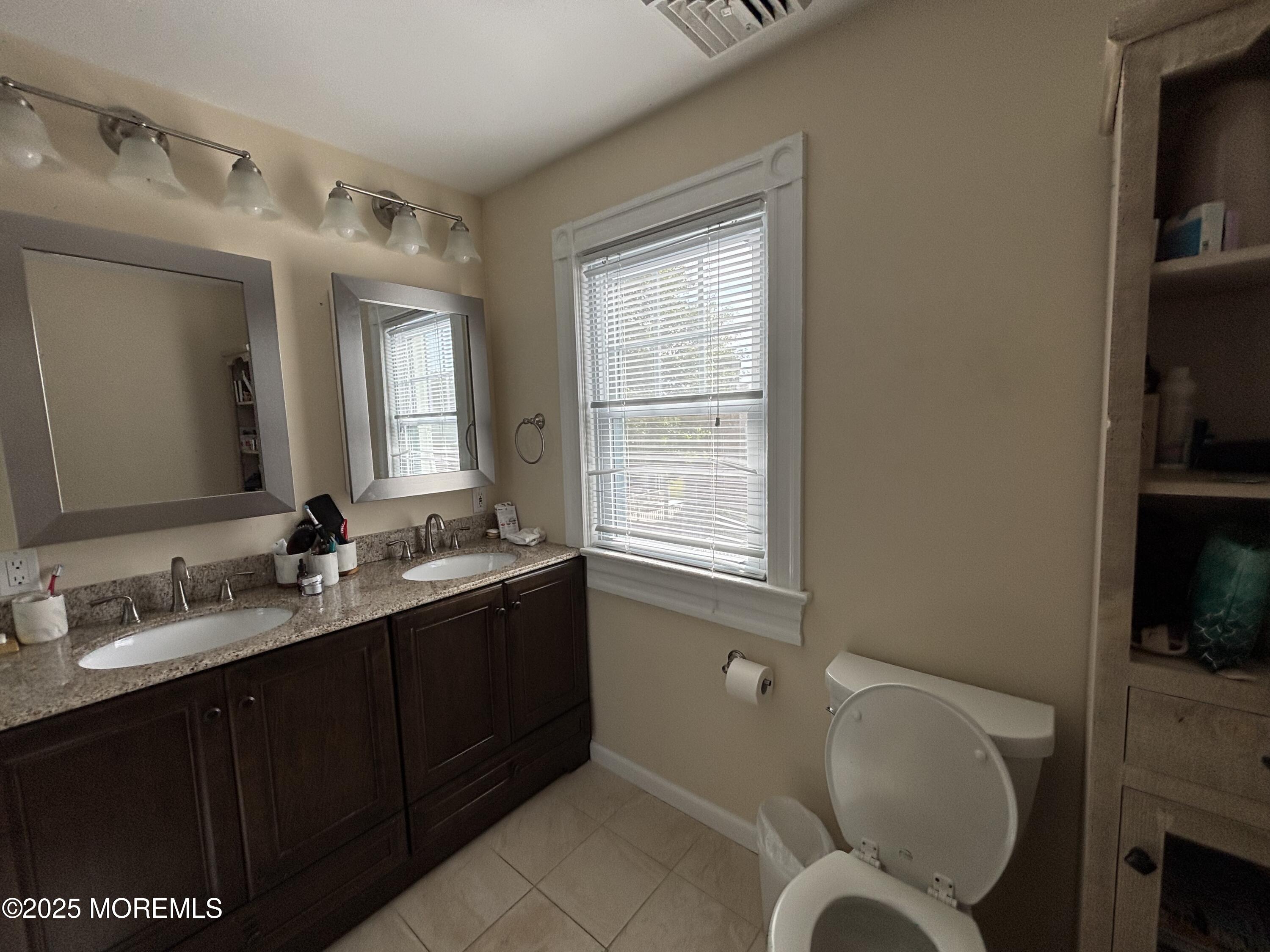 516 2nd Avenue Long Branch, NJ 07740 - Photo 23 of 52 a bathroom with a granite countertop sink mirror and toilet