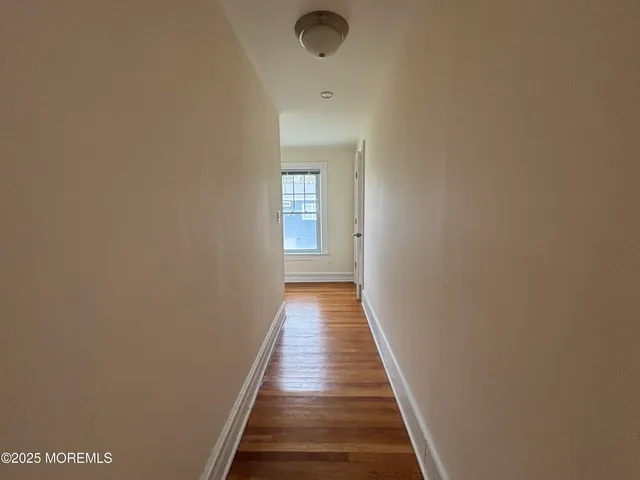 a spacious bedroom with two beds and a chandelier