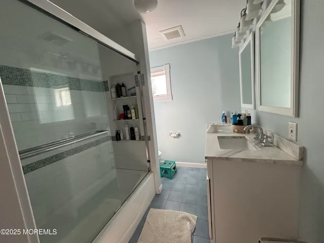 a bedroom with two beds and a chandelier