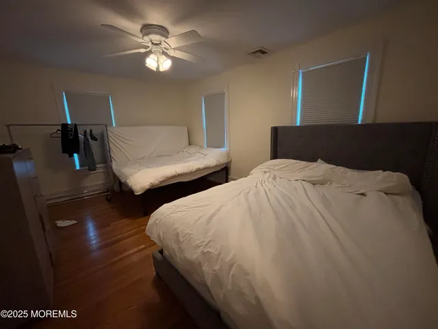 a bedroom with a bed and a mirror