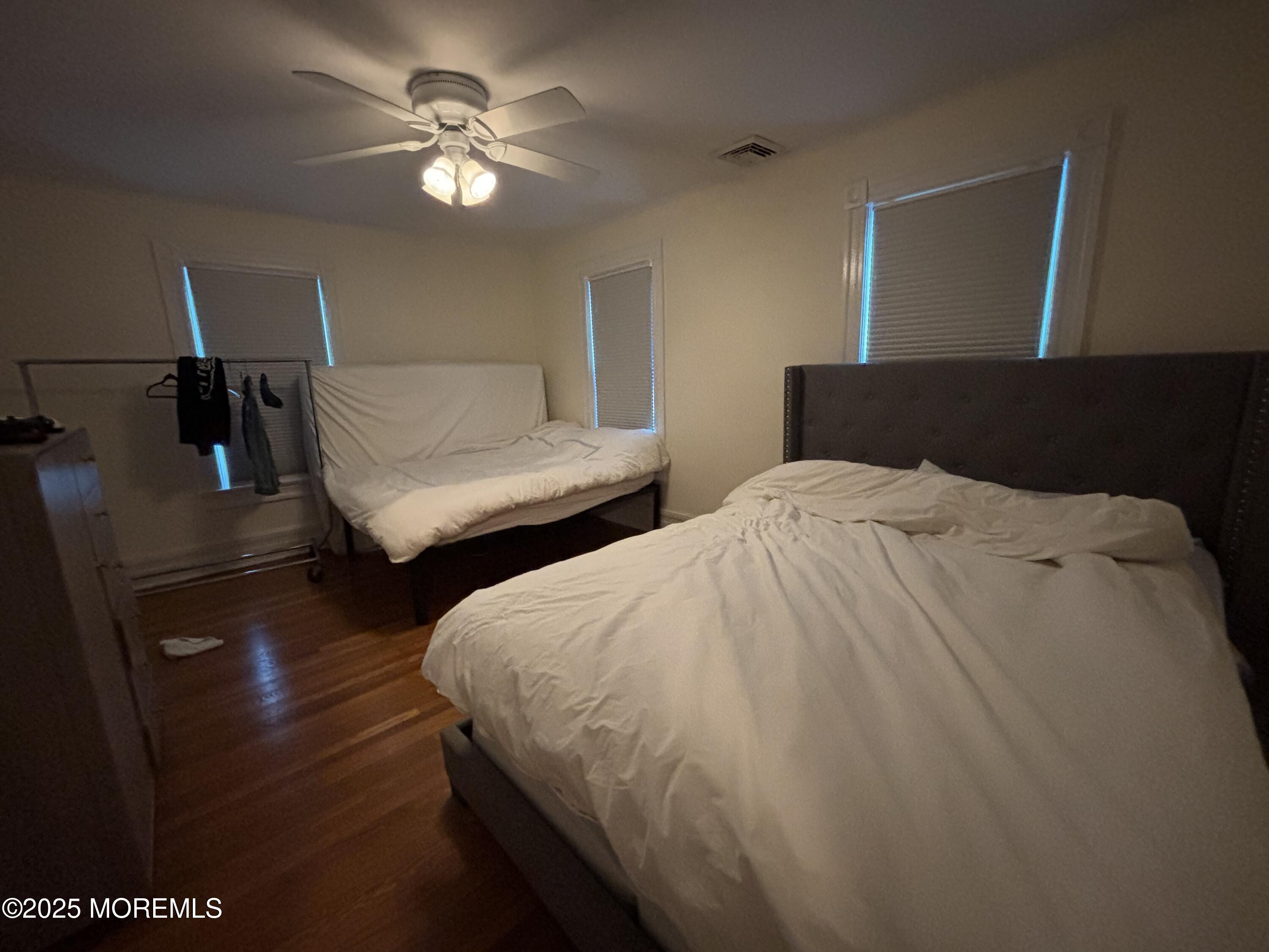 516 2nd Avenue Long Branch, NJ 07740 - Photo 30 of 52 a spacious bedroom with two beds and a chandelier