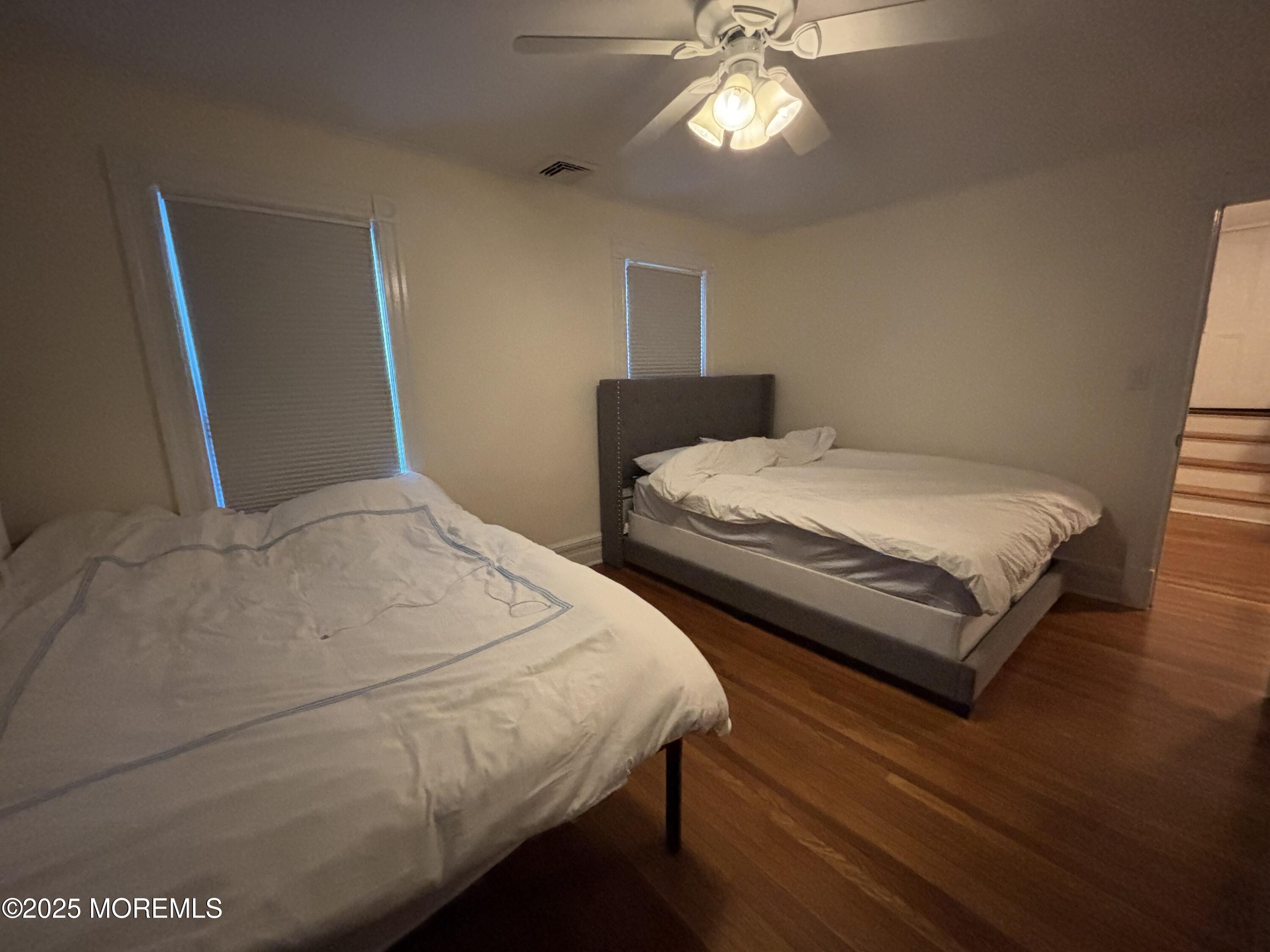 516 2nd Avenue Long Branch, NJ 07740 - Photo 31 of 52 a bedroom with two beds and a chandelier