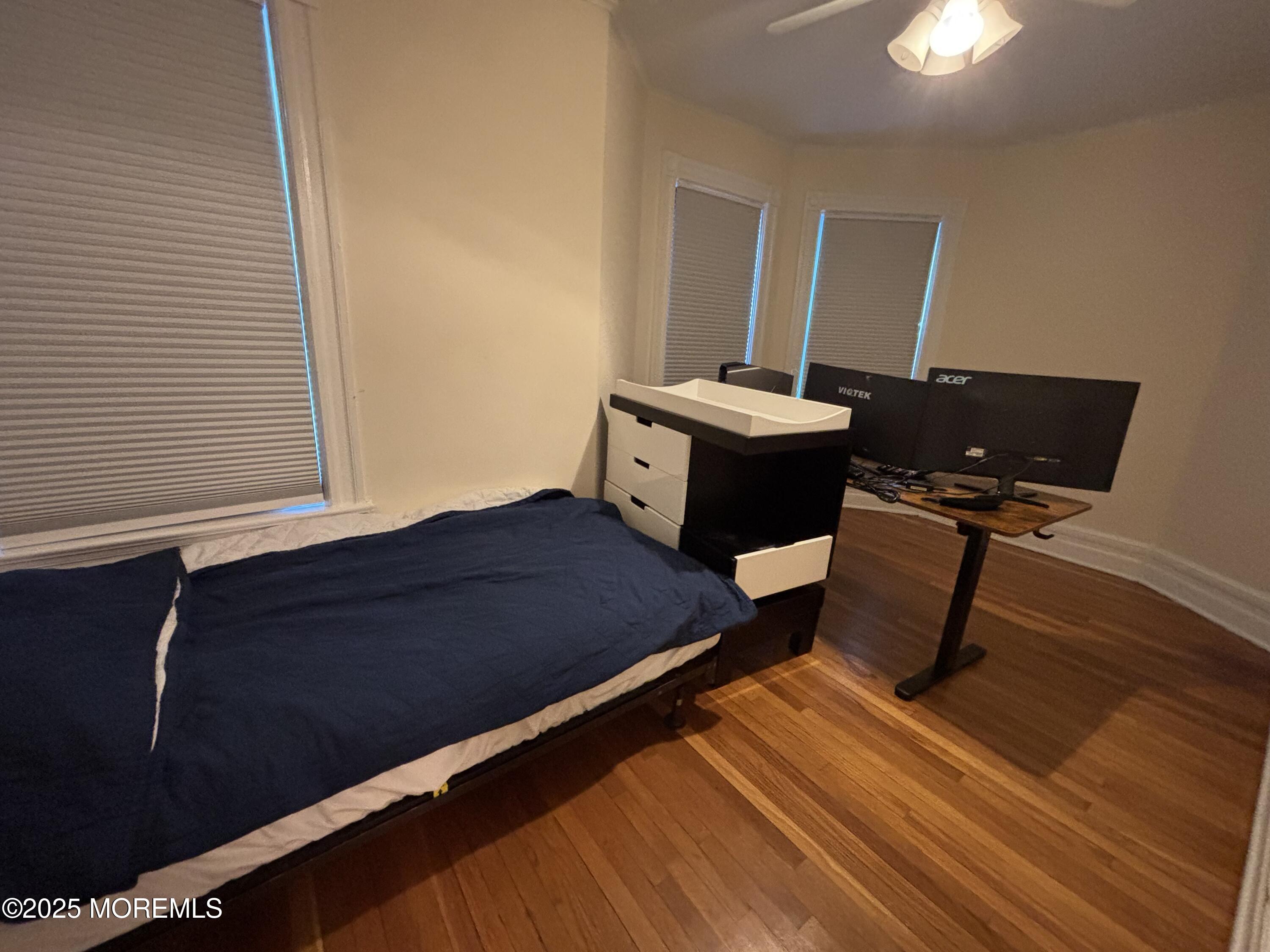516 2nd Avenue Long Branch, NJ 07740 - Photo 33 of 52 a bedroom with a bed and a mirror