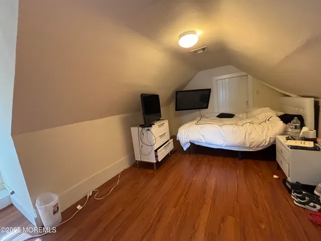 a bedroom with a bed and a mirror