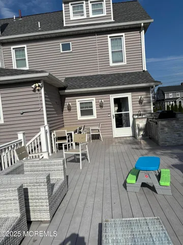 a view of deck with seating area and trees