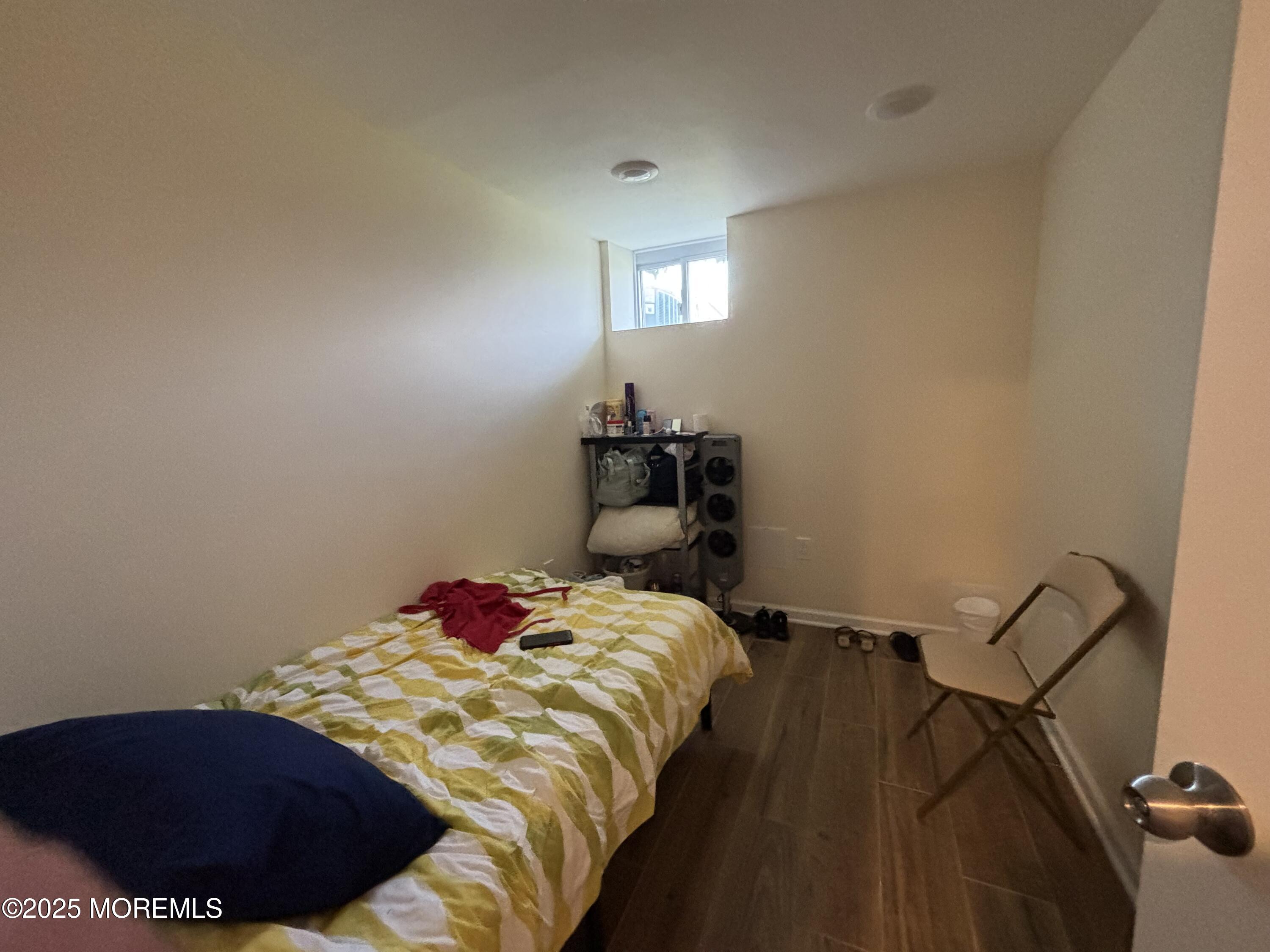 516 2nd Avenue Long Branch, NJ 07740 - Photo 46 of 52 a bedroom with a bed and a lamp on dresser