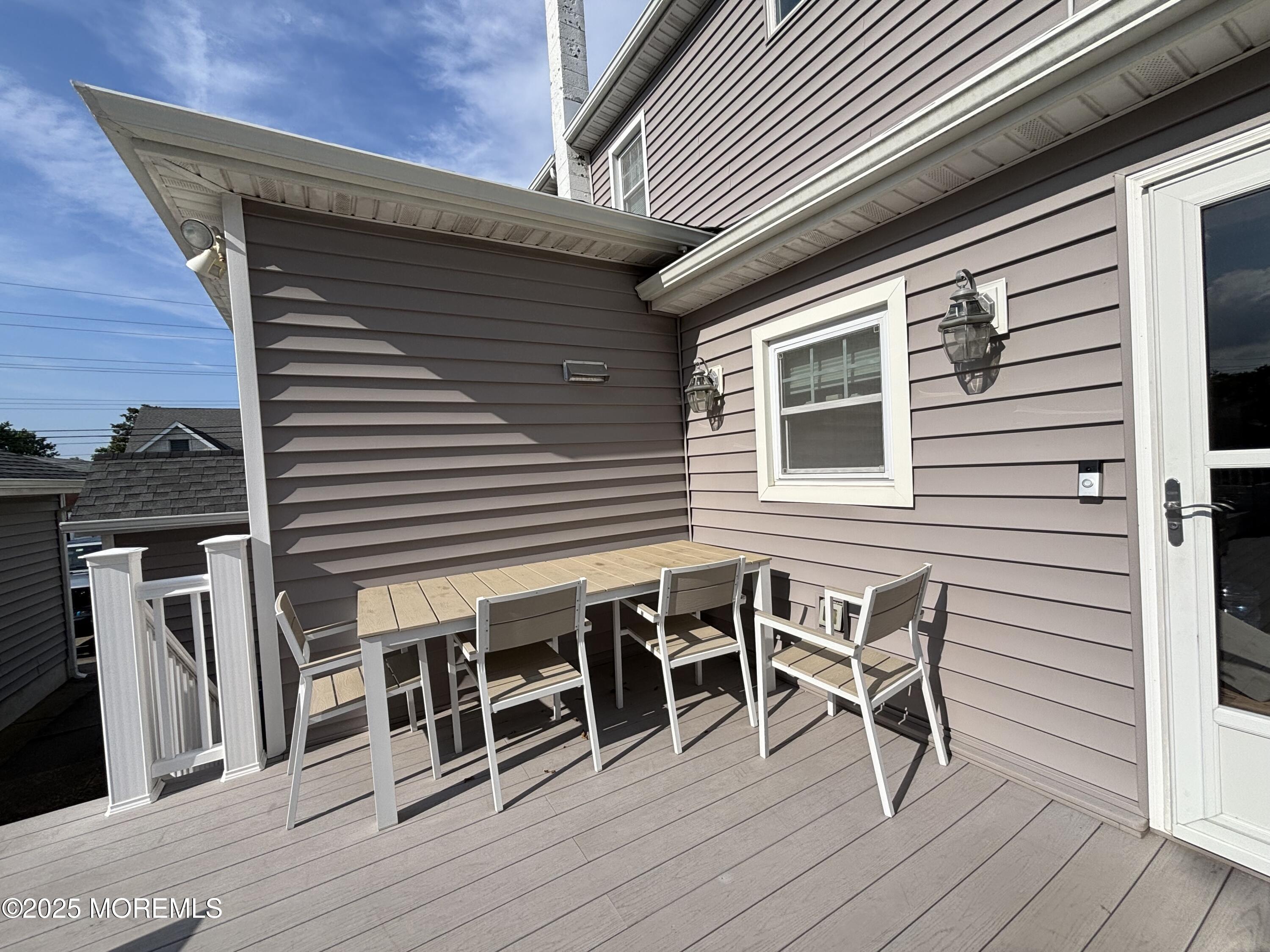 516 2nd Avenue Long Branch, NJ 07740 - Photo 52 of 52 a balcony with table and chairs