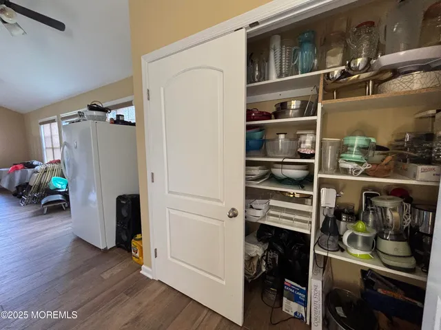 a view of a dining room with furniture and wooden floor