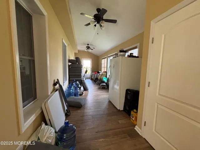 a living room with furniture a bed and a flat screen tv