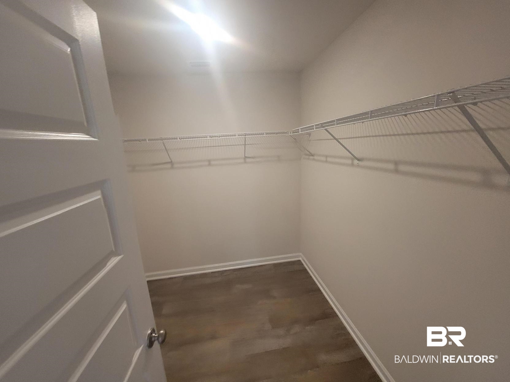 24625 Ponder Loop Loxley, AL 36551 - Photo 21 of 30 Walk in closet with dark wood-type flooring