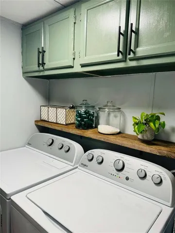 a bathroom with a double vanity sink toilet and mirror