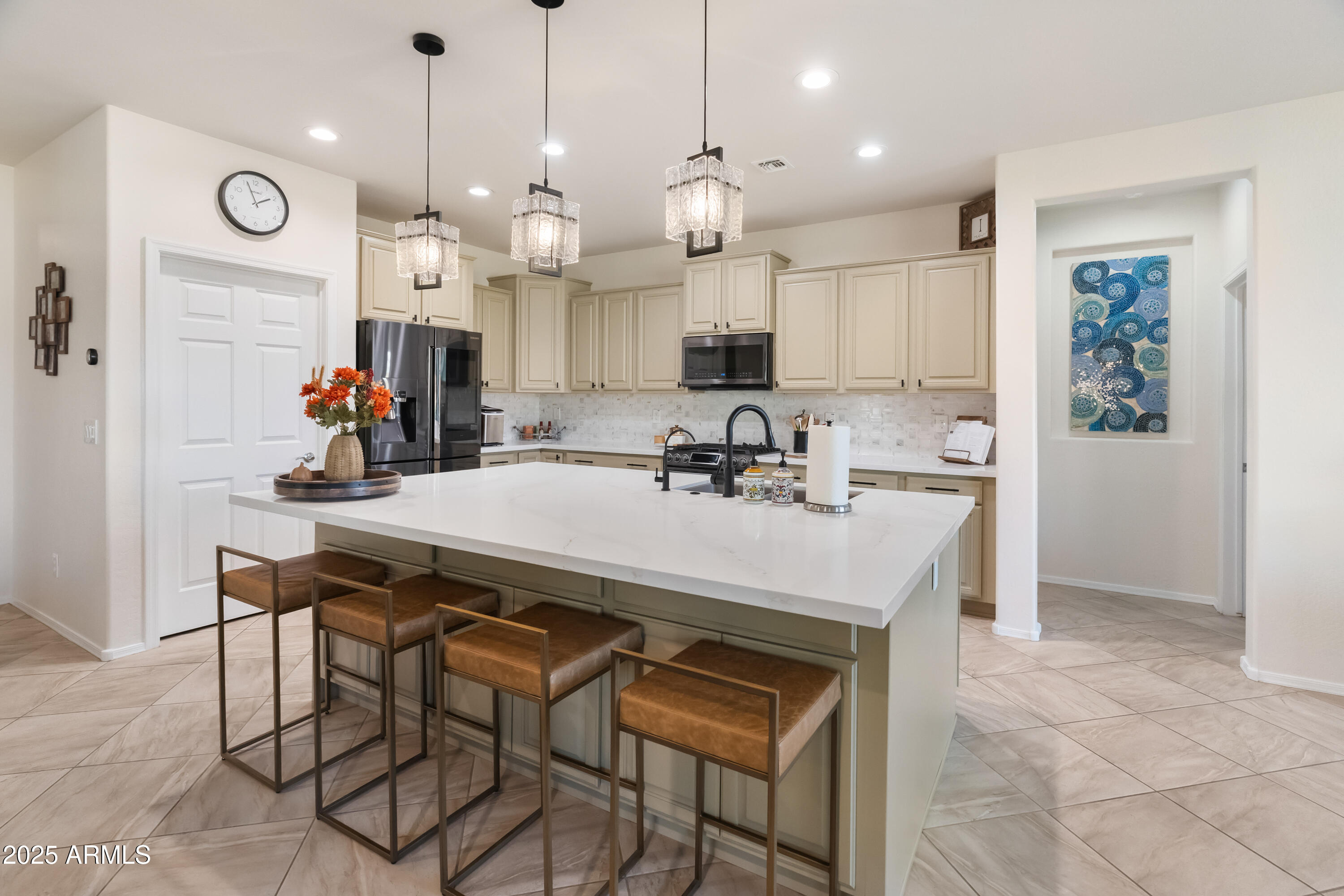 26990 West Utopia Road Buckeye, AZ 85396 - Photo 10 of 41 a kitchen with a sink a refrigerator and chairs