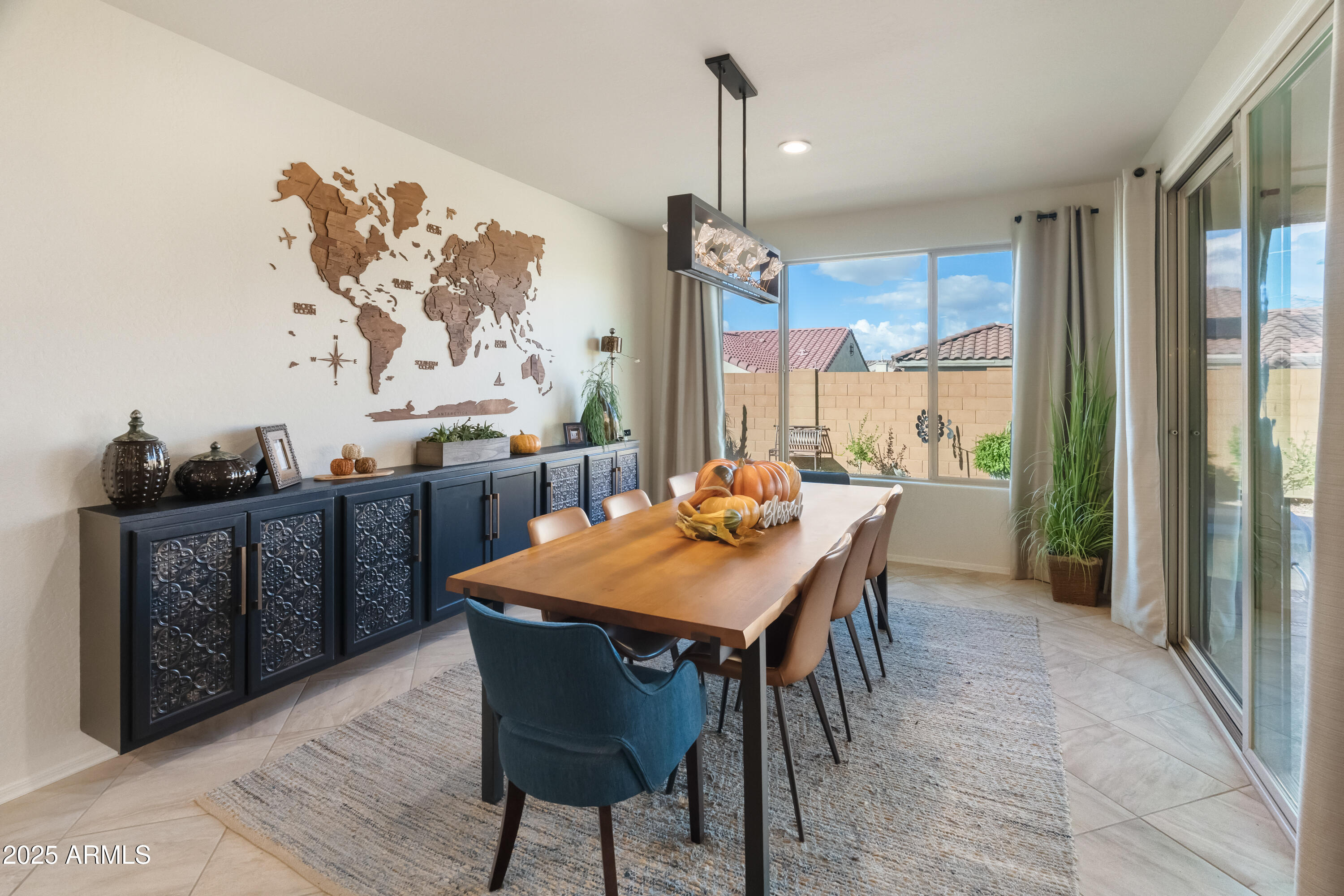 26990 West Utopia Road Buckeye, AZ 85396 - Photo 12 of 41 a dining room with a wooden table and chairs