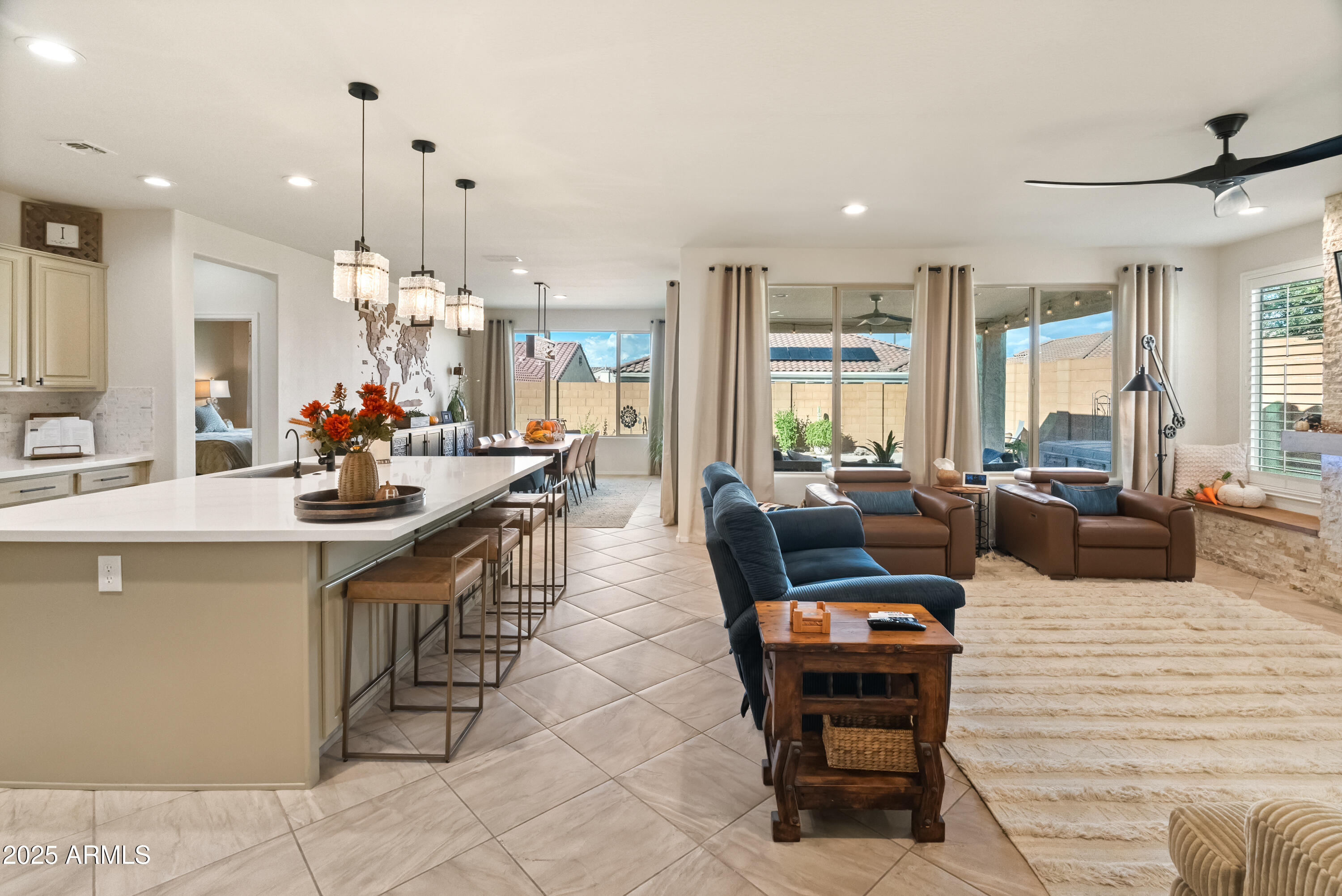 26990 West Utopia Road Buckeye, AZ 85396 - Photo 14 of 41 a living room with lots of furniture and a chandelier