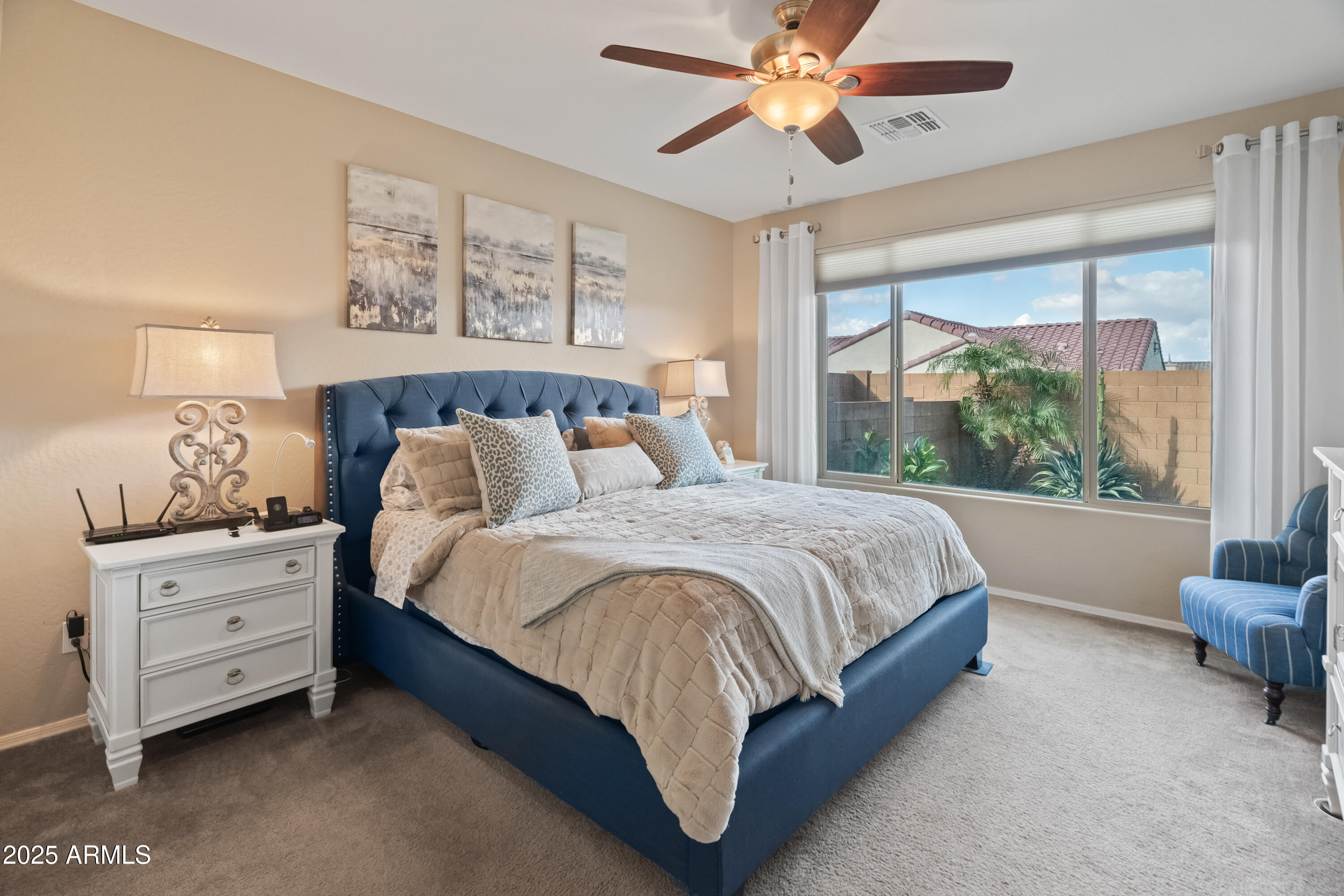 26990 West Utopia Road Buckeye, AZ 85396 - Photo 18 of 41 a spacious bedroom with a bed dresser and a window