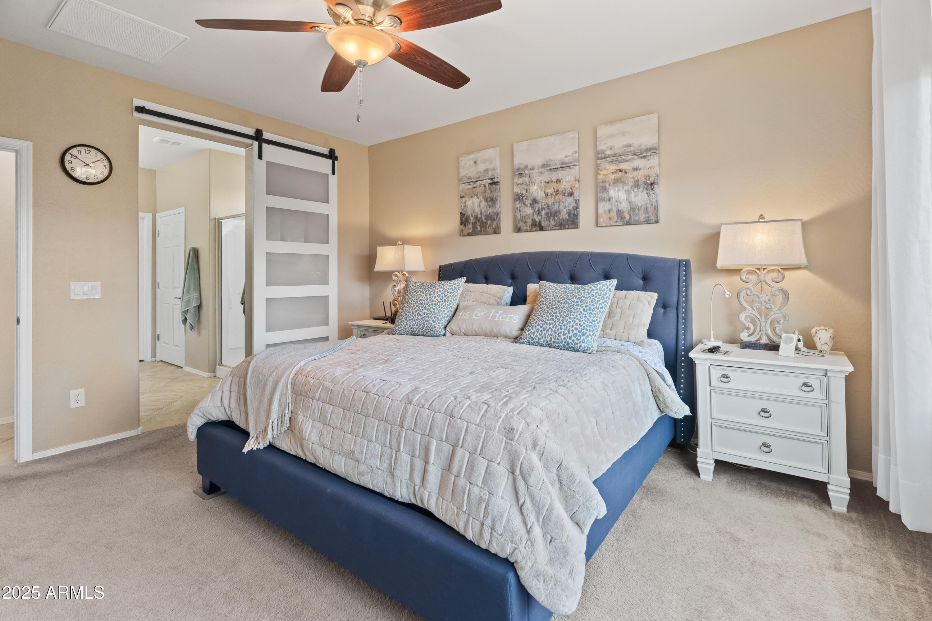 26990 West Utopia Road Buckeye, AZ 85396 - Photo 19 of 41 a bedroom with a bed and a chandelier