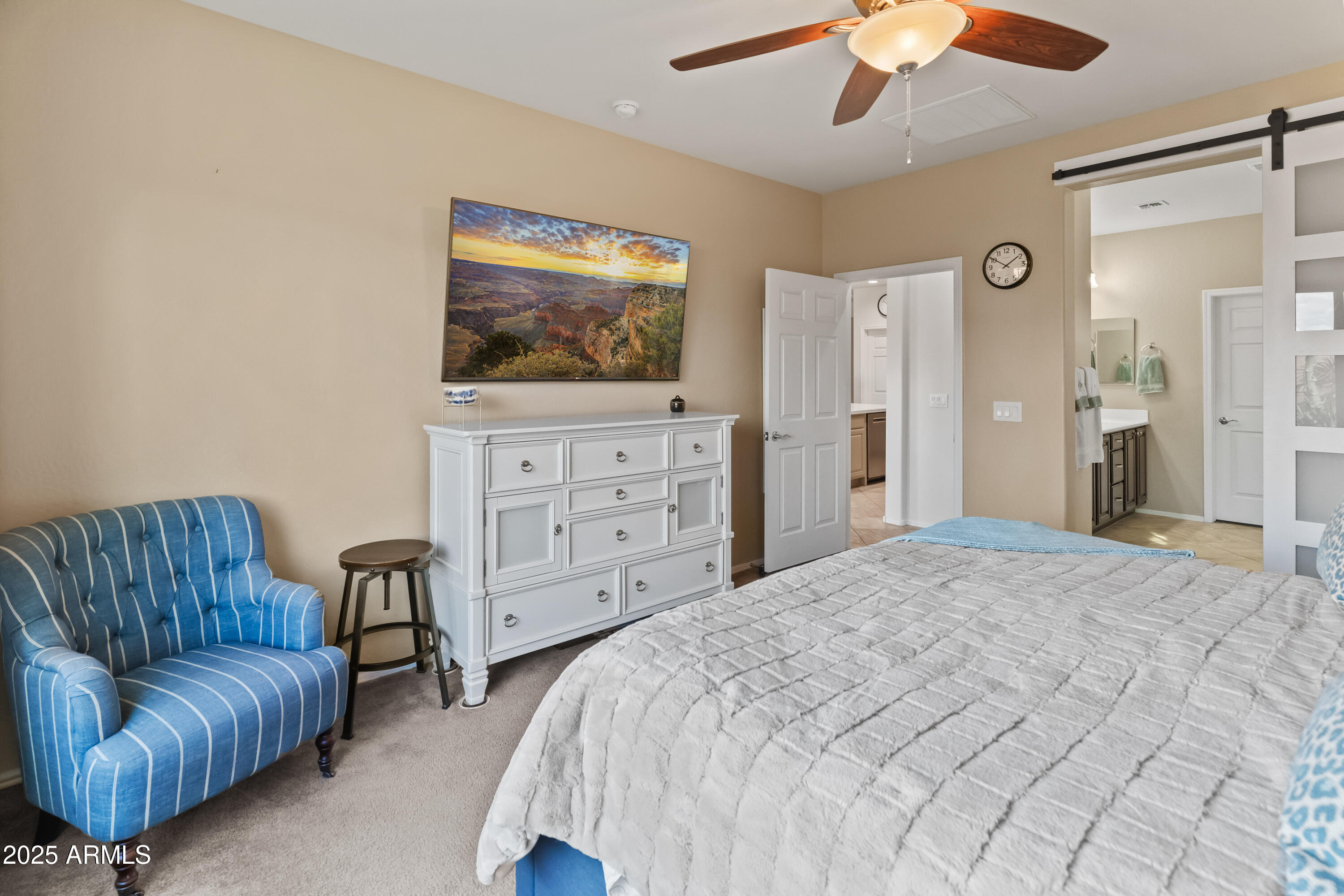 26990 West Utopia Road Buckeye, AZ 85396 - Photo 20 of 41 a spacious bedroom with a bed and couch