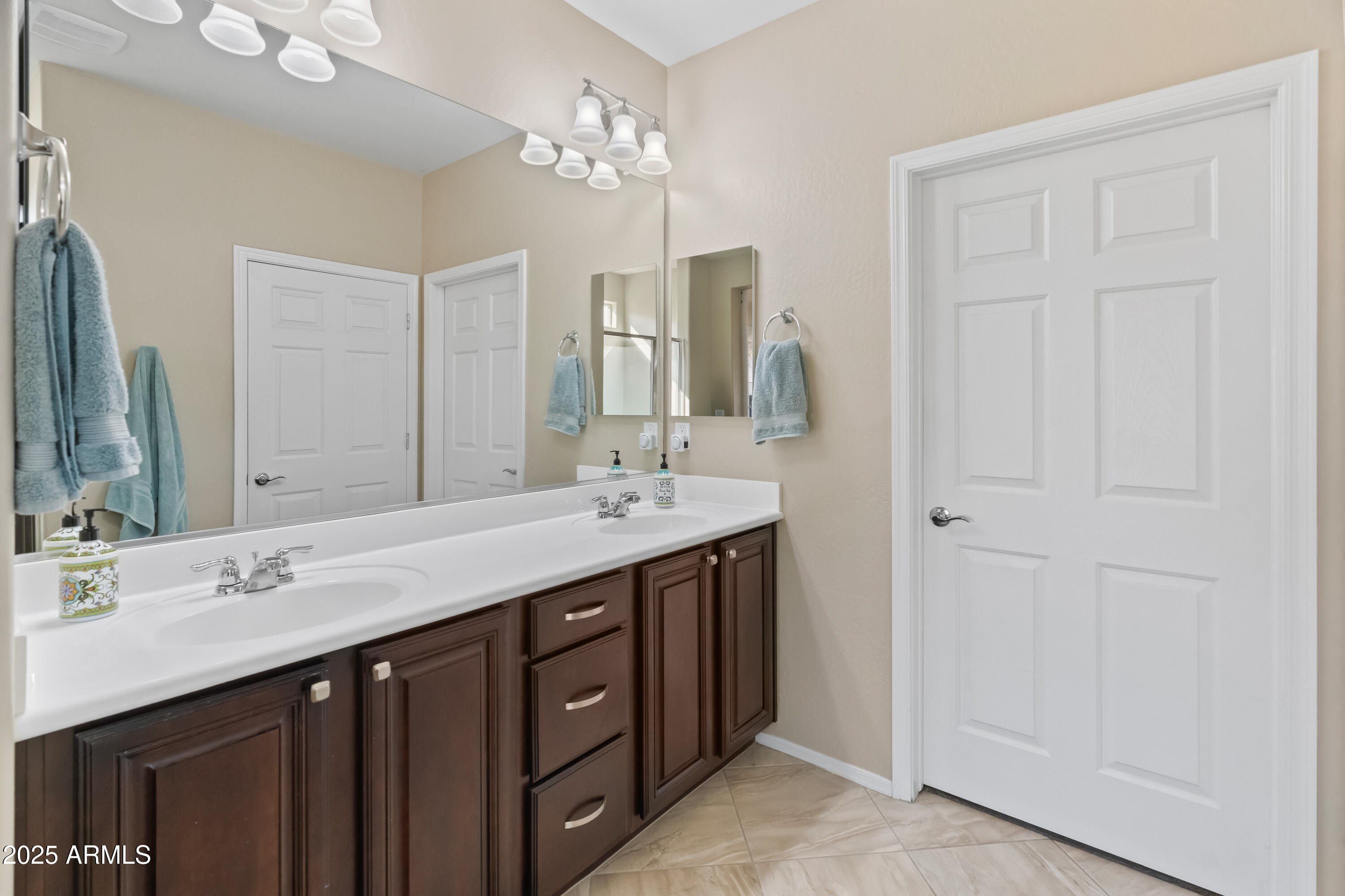 26990 West Utopia Road Buckeye, AZ 85396 - Photo 21 of 41 a bathroom with double sink and a mirror