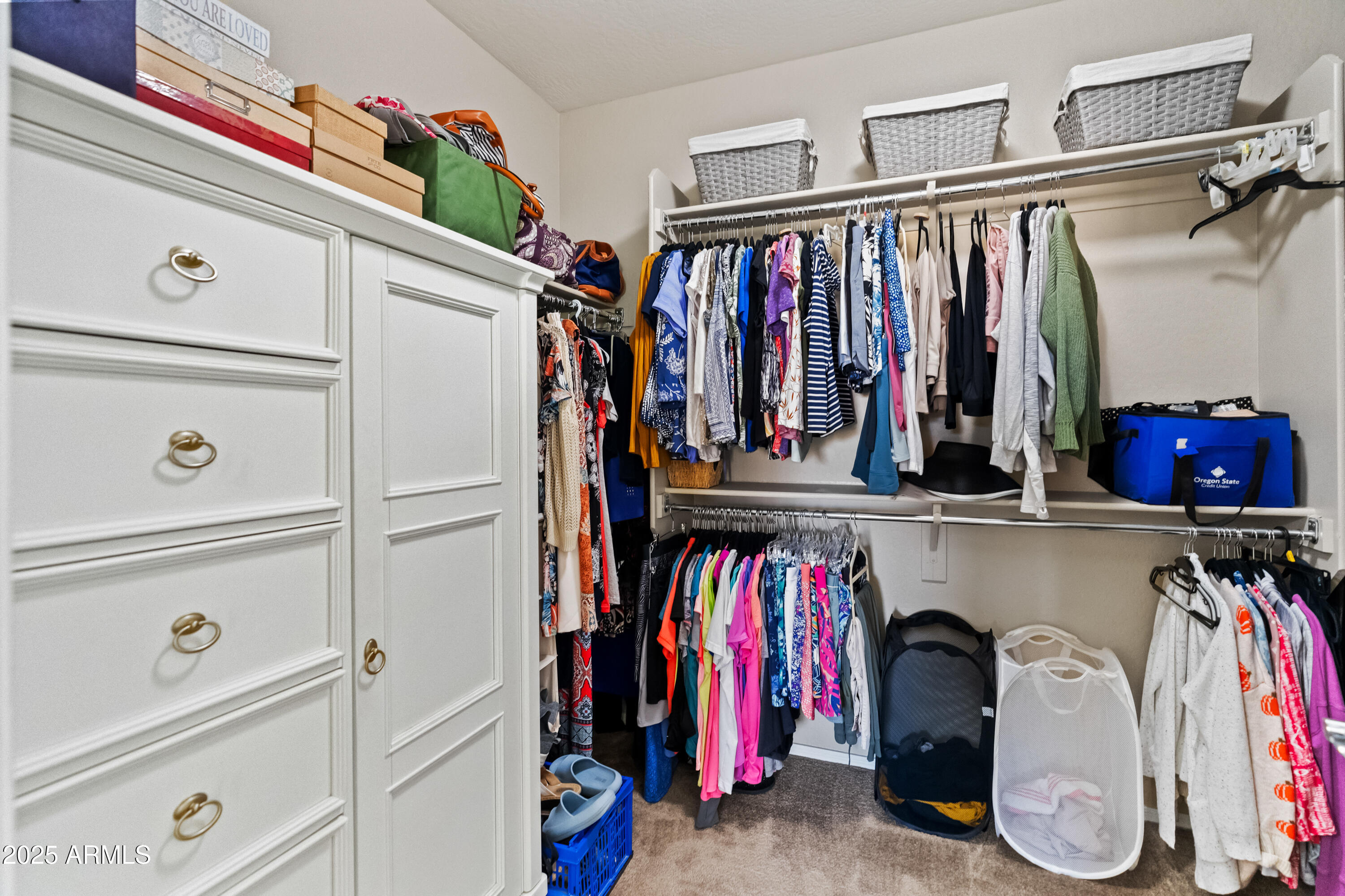 26990 West Utopia Road Buckeye, AZ 85396 - Photo 23 of 41 a view of walk in closet with clothes and shoes