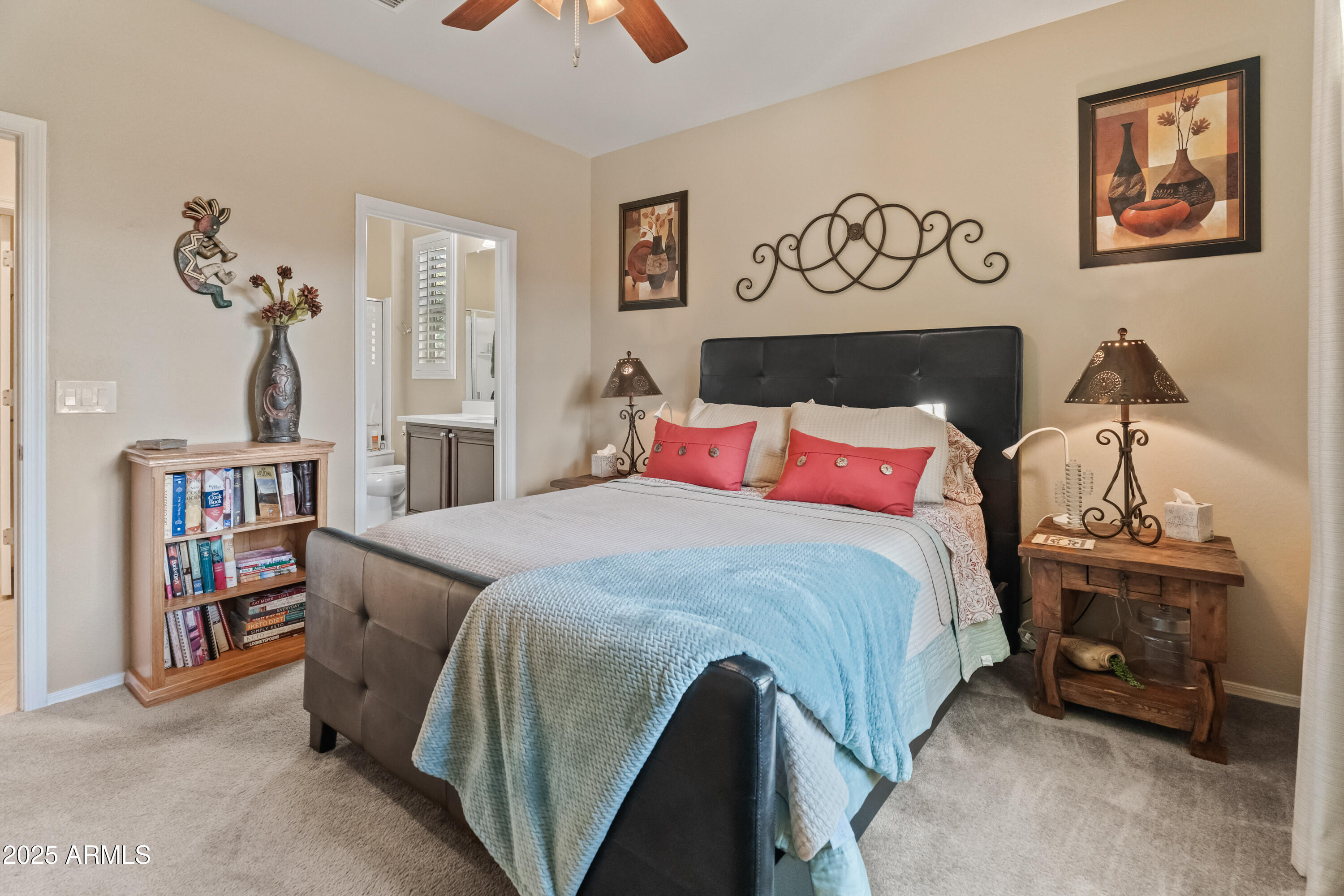 26990 West Utopia Road Buckeye, AZ 85396 - Photo 25 of 41 a bedroom with a bed and a book shelf