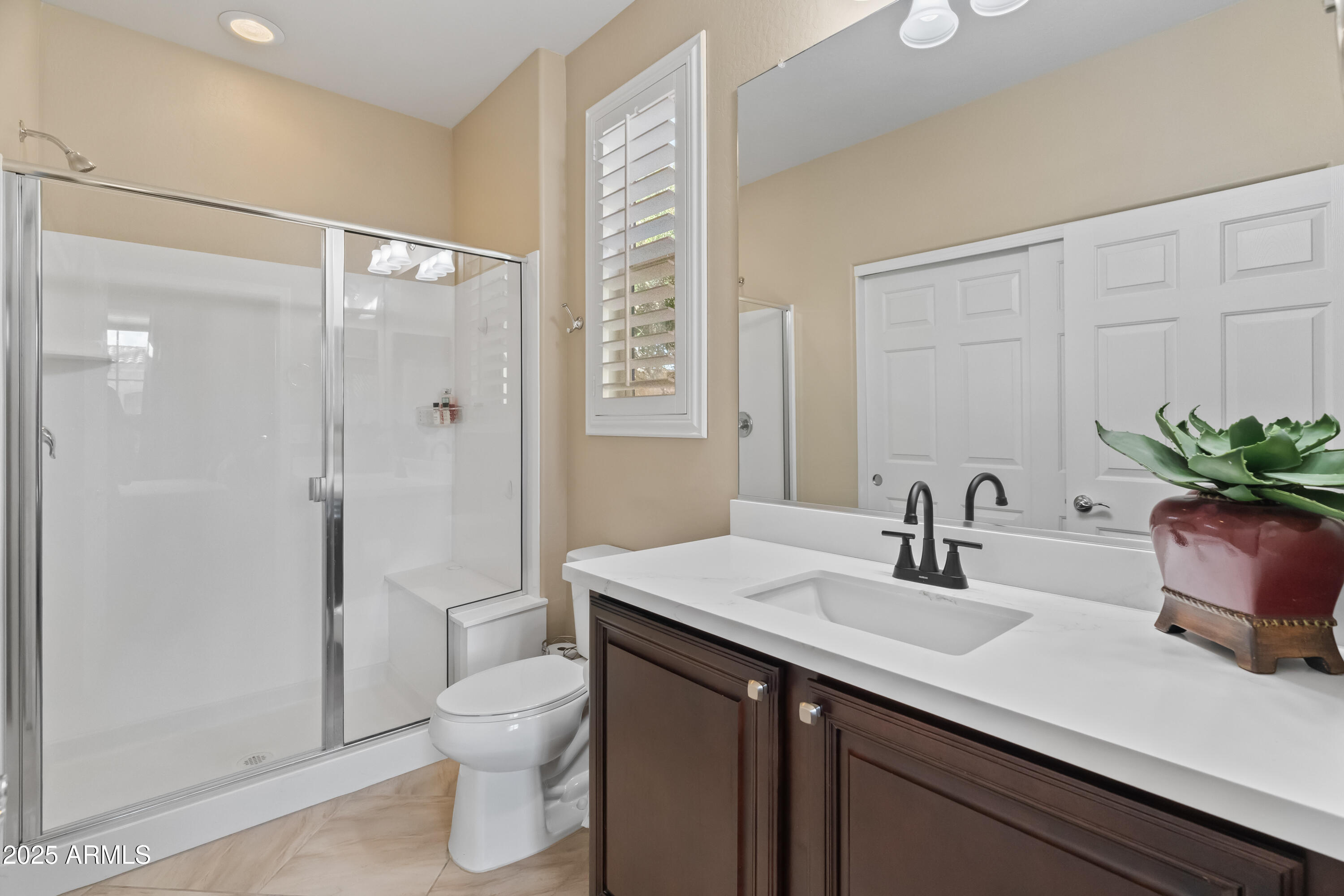 26990 West Utopia Road Buckeye, AZ 85396 - Photo 26 of 41 a bathroom with a sink a toilet and shower