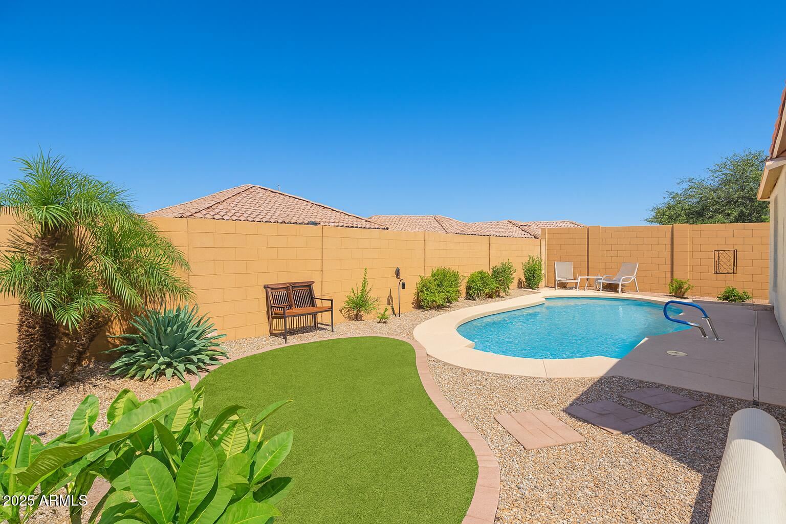 26990 West Utopia Road Buckeye, AZ 85396 - Photo 39 of 41 a view of a swimming pool with a yard