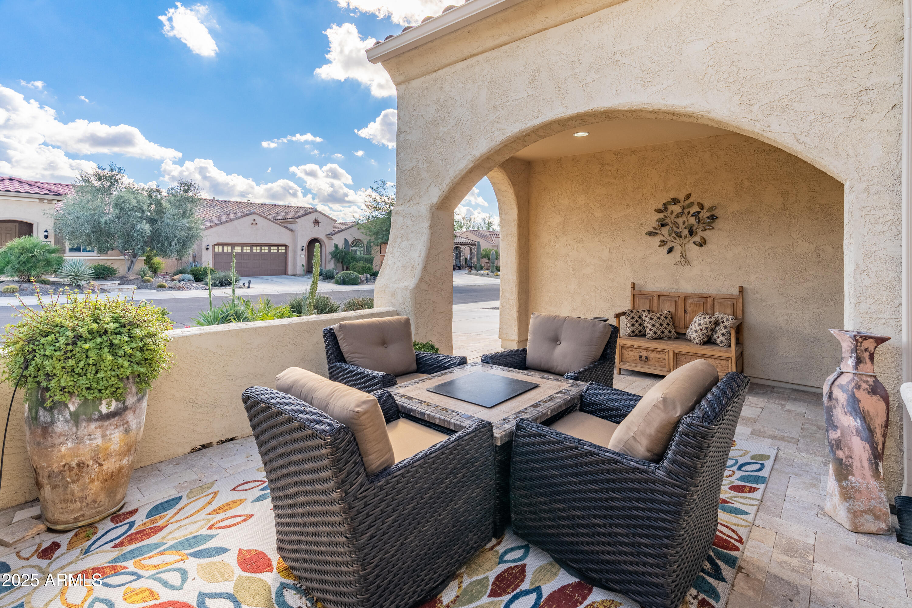 26990 West Utopia Road Buckeye, AZ 85396 - Photo 4 of 41 a view of a patio with couches table and chairs and potted plants