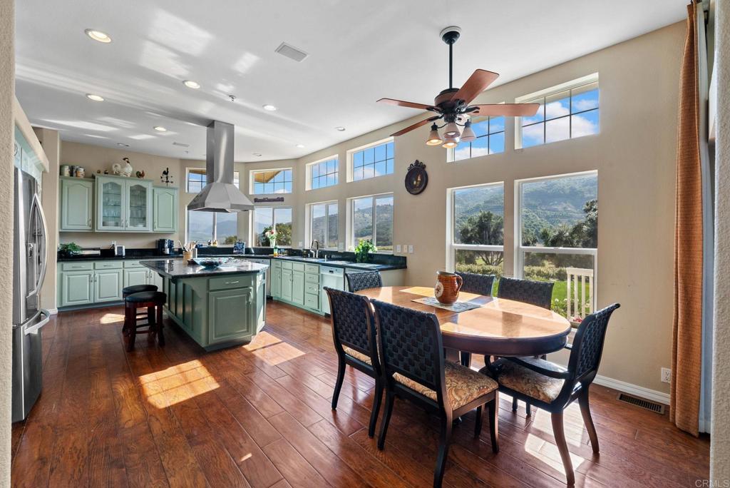 Undisclosed Address Valley Center, CA 92082 - Photo 17 of 60 a dining hall with stainless steel appliances granite countertop a stove a kitchen island a dining table and chairs