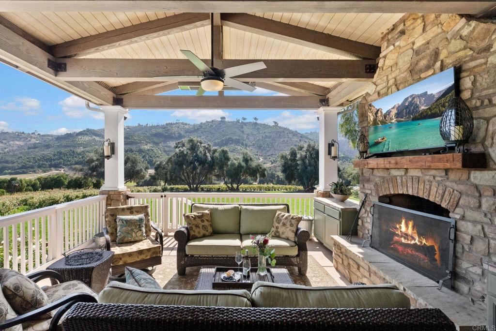 Undisclosed Address Valley Center, CA 92082 - Photo 18 of 60 a living room with fireplace furniture and a floor to ceiling window