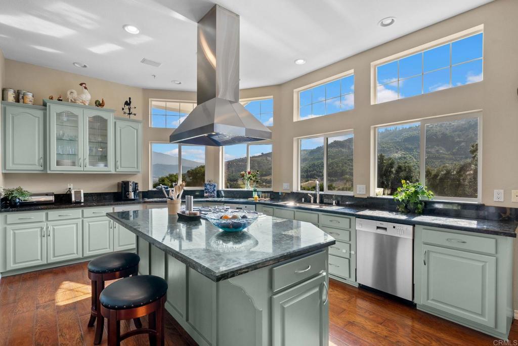 Undisclosed Address Valley Center, CA 92082 - Photo 21 of 60 a kitchen with stainless steel appliances granite countertop a sink a stove and a wooden floors
