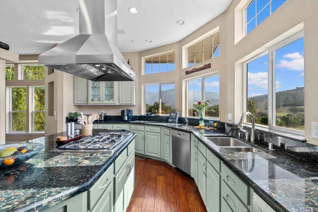 Undisclosed Address Valley Center, CA 92082 - Photo 22 of 60 a kitchen with stainless steel appliances granite countertop a sink a stove and a wooden cabinets