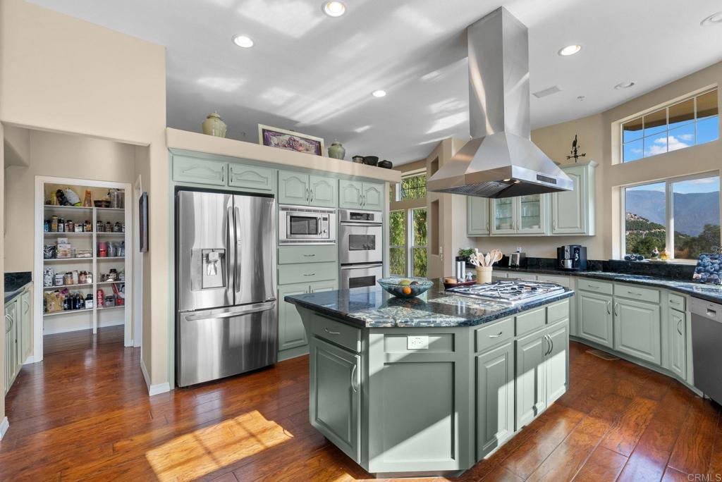 Undisclosed Address Valley Center, CA 92082 - Photo 23 of 60 a kitchen with stainless steel appliances granite countertop a sink and a refrigerator