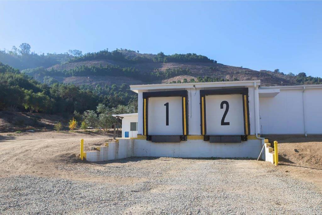 Undisclosed Address Valley Center, CA 92082 - Photo 52 of 60 a front view of a house with a yard and garage