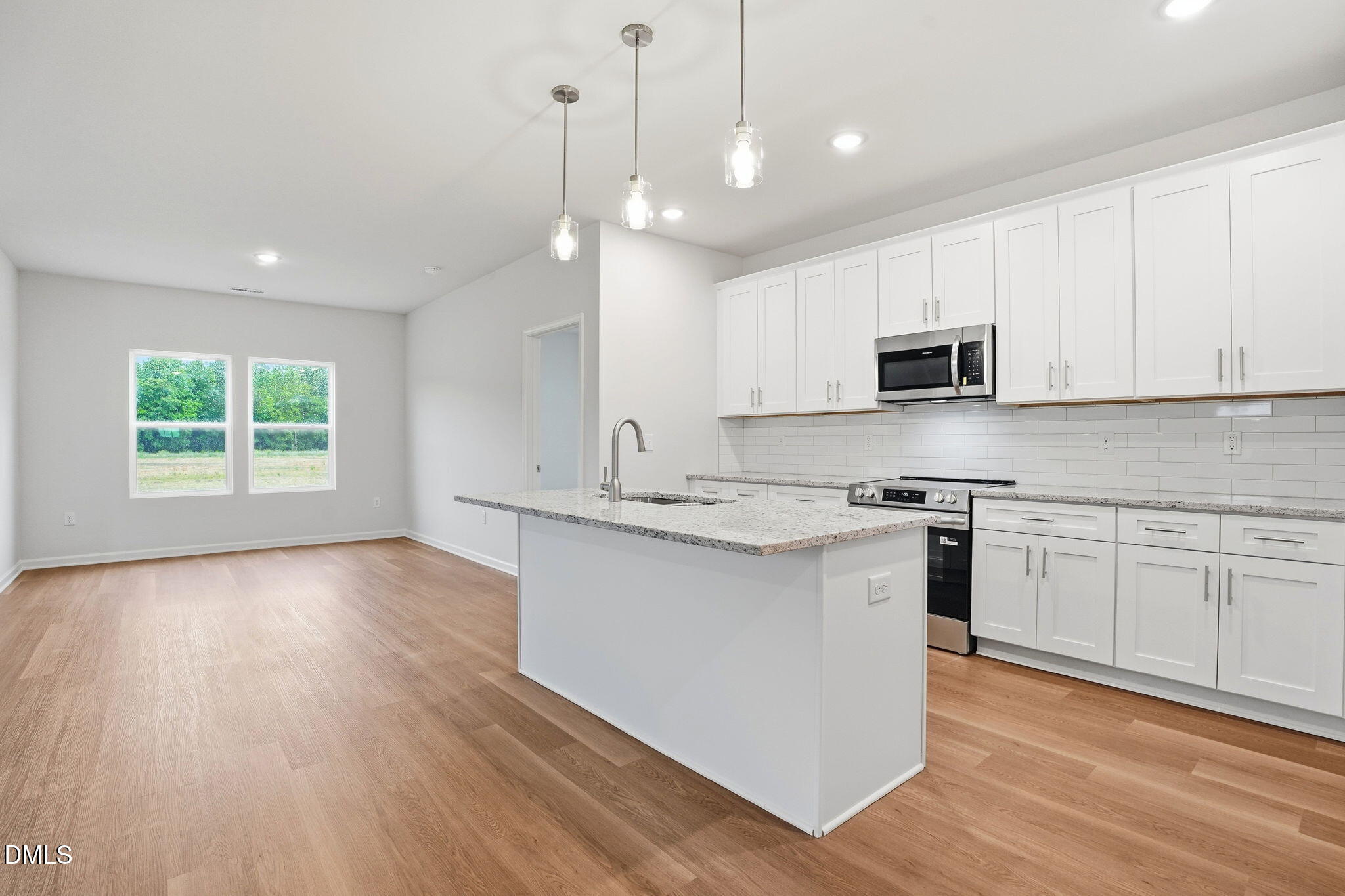 9019 Phoenix Court Spring Hope, NC 27882 - Photo 12 of 34 a kitchen with kitchen island granite countertop a sink a counter space appliances and cabinets