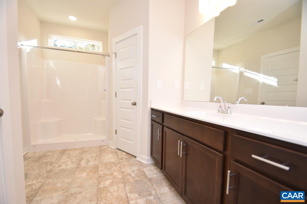 1060 Hanback Road Gordonsville, VA 22942 - Photo 14 of 19 a bathroom with a double vanity sink a mirror and shower