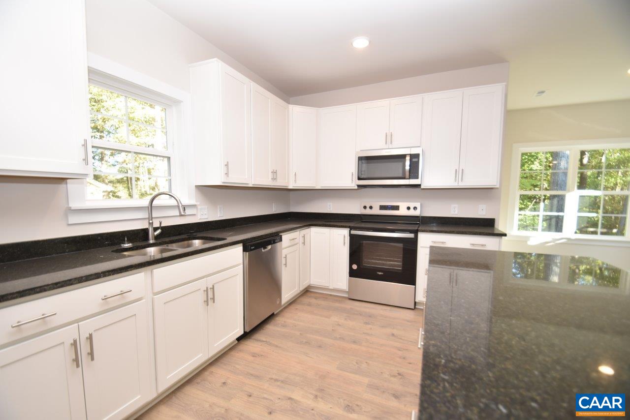 1060 Hanback Road Gordonsville, VA 22942 - Photo 9 of 19 a kitchen with granite countertop white cabinets and black stainless steel appliances
