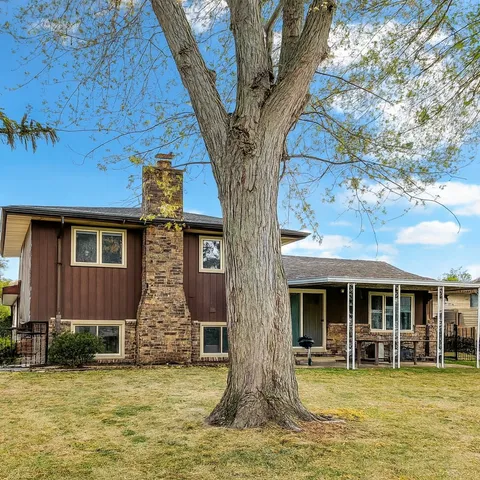 a view of a house with pool and sitting area